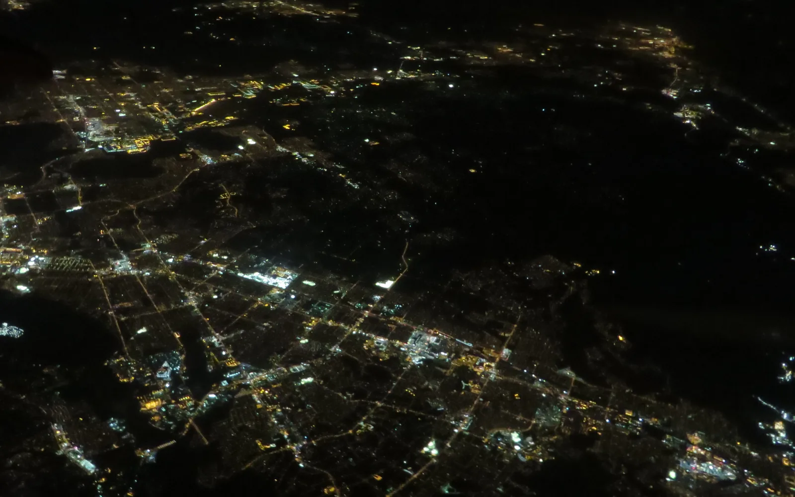 Nighttime aerial view of the Inland Empire's urban sprawl lighting the landscape